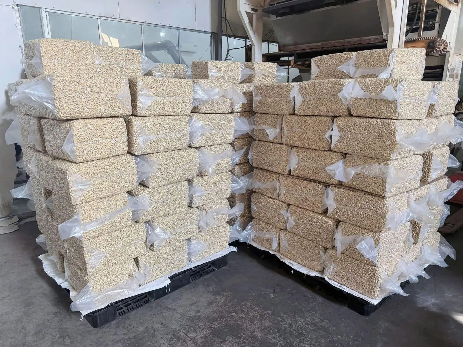 Palletised vacuum bags of cashew kernels in the warehouse