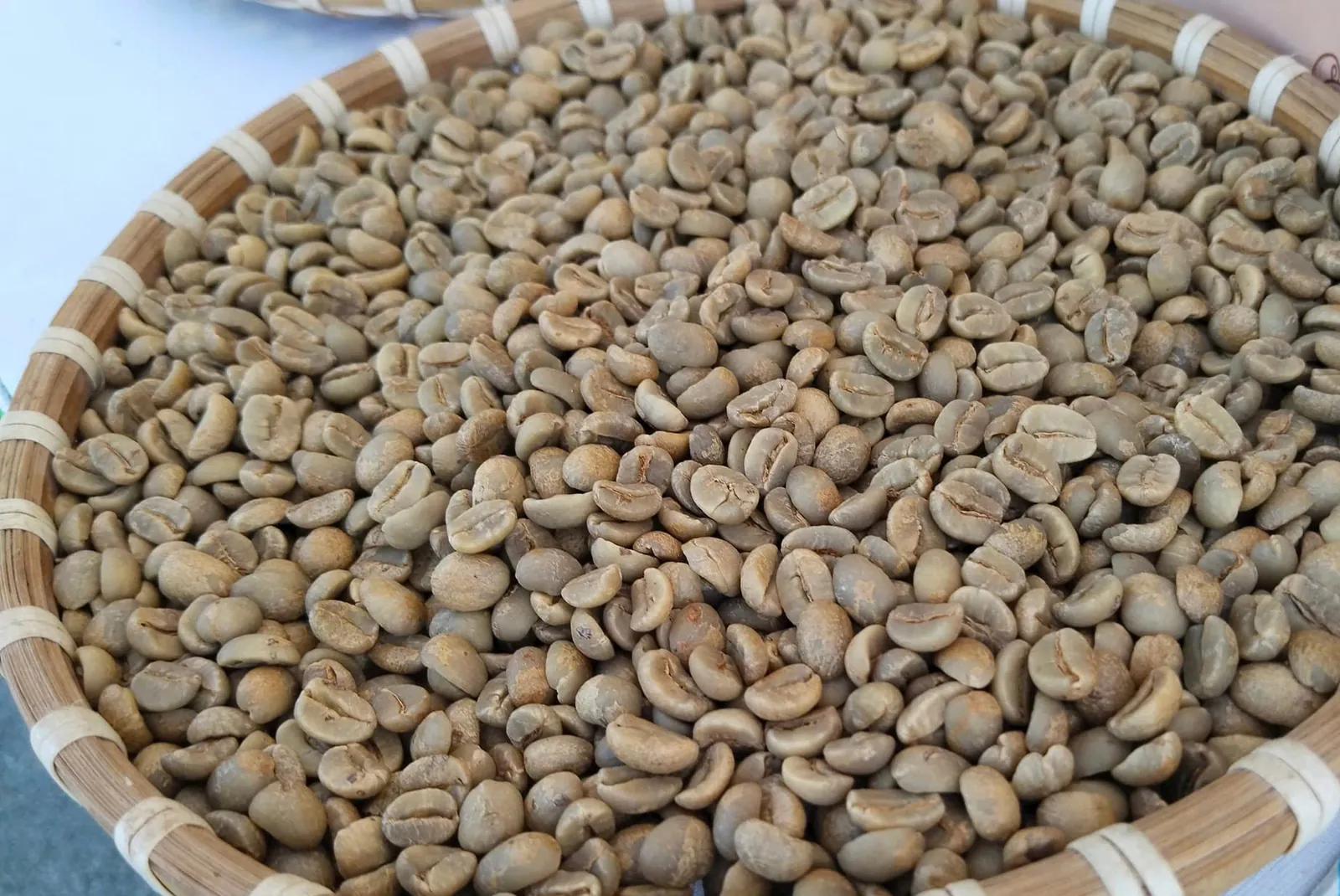 Green Arabica beans in a bamboo basket