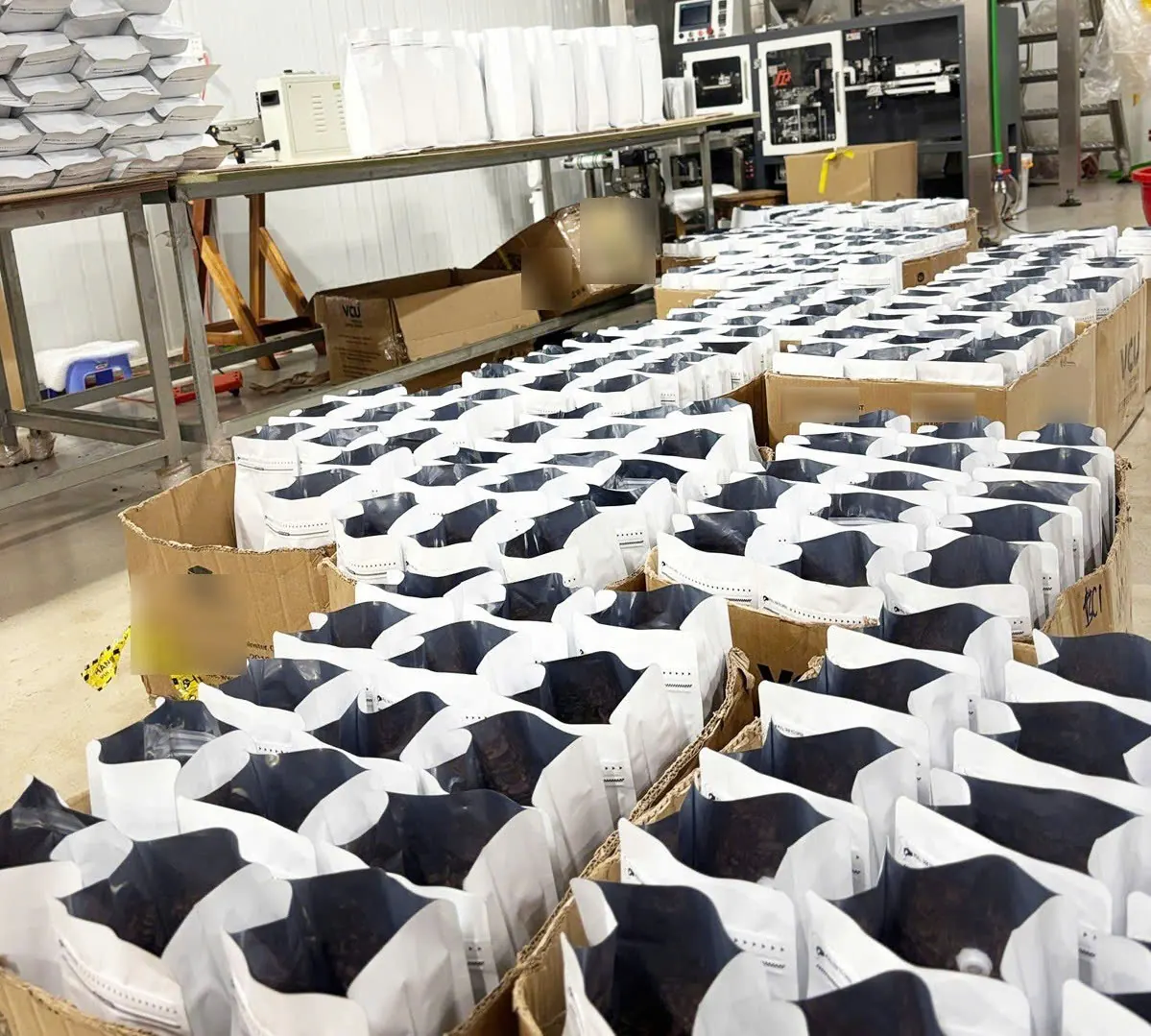 Bags of roasted coffee on the packing line