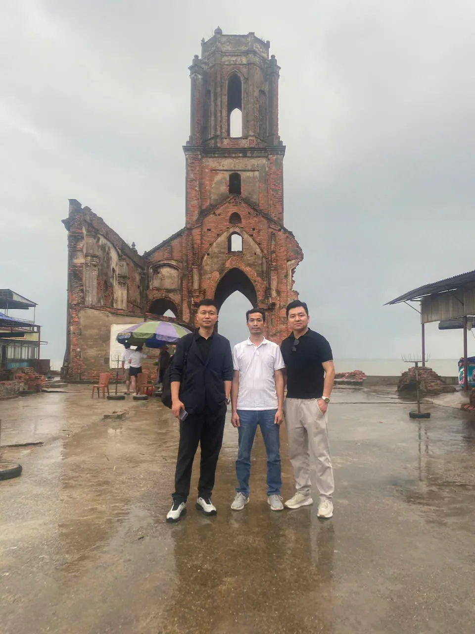 With visiting partners at the Hai Ly church ruins, Nam Dinh